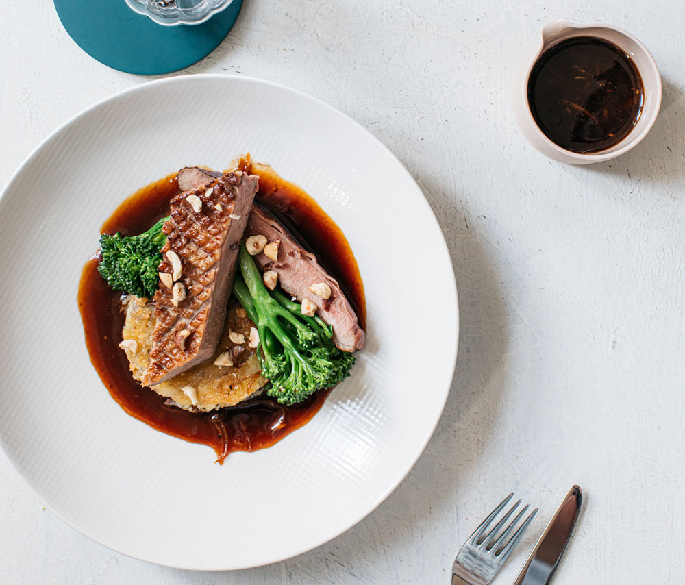 Honey-glazed duck breast, red onion & hazelnut rosti, tenderstem broccoli & Cumberland sauce
