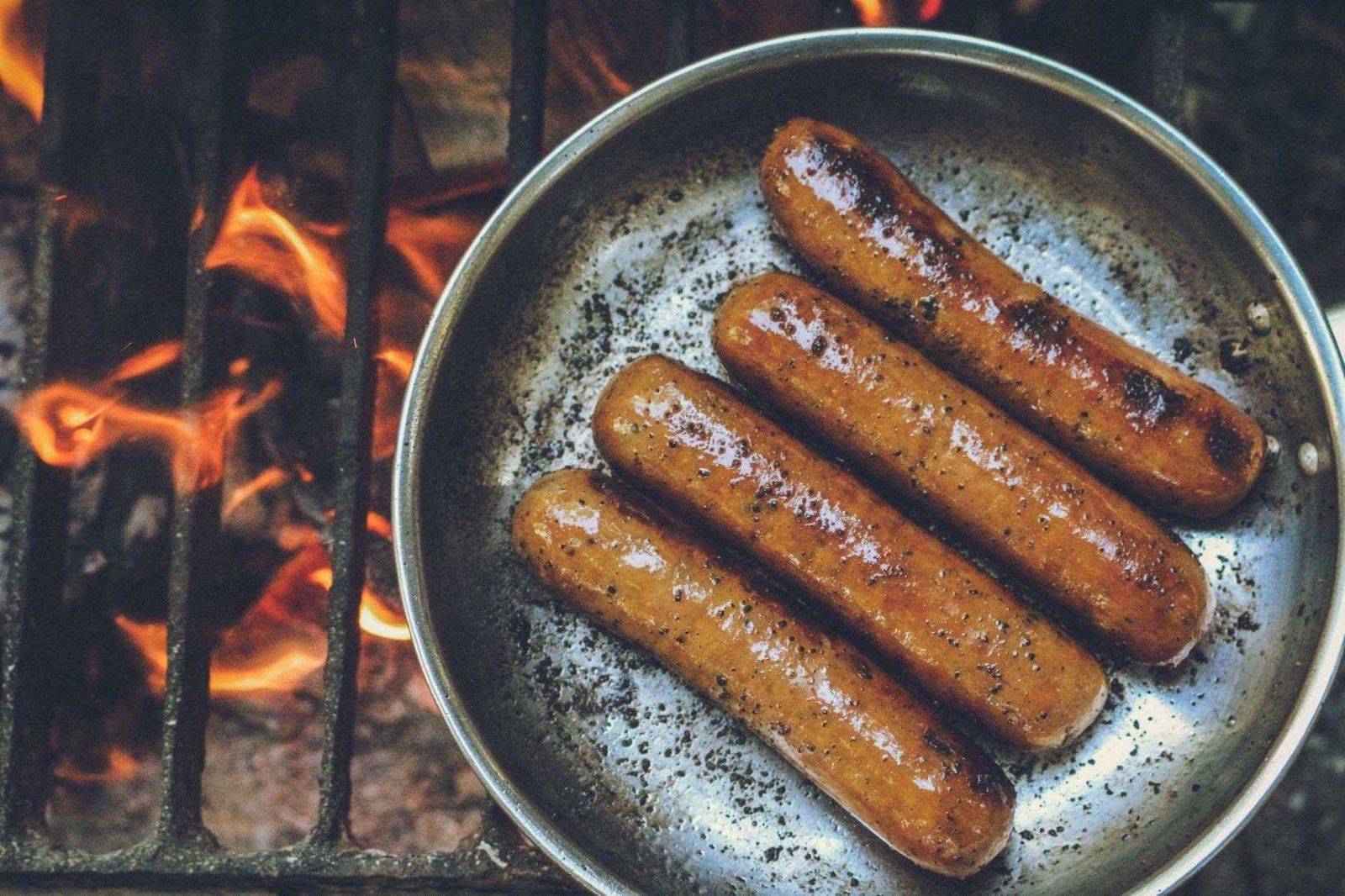 Sausages cooking in a pan