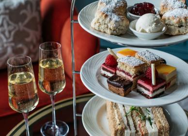 Afternoon tea close up with two glasses of Prosecco on the side
