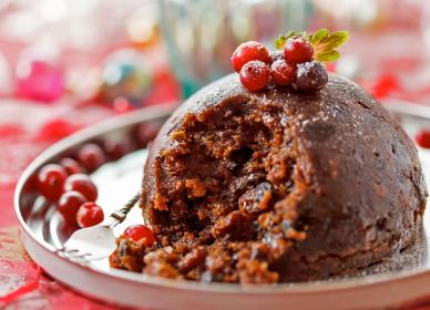 Christmas pudding with cranberries on a plate.