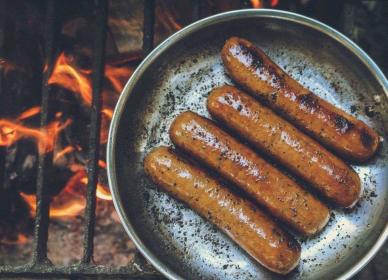 Sausages cooking in a pan