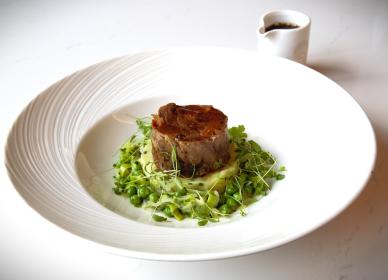 Slow braised lamb Henry served with olive oil crushed potatoes, leek and pea fricasse and a mint jus
