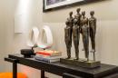 A black table with a couple of statues on it.