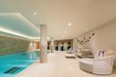 A swimming pool in a large living room.