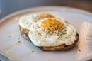 Two fried eggs on toast on a plate.
