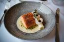 Salmon on a plate with a fork and knife.
