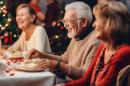 A group of older people sitting at a table at a christmas party.