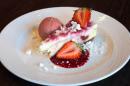 White chocolate and raspberry cheesecake, served with strawberries, strawberry coulis, raspberry sorbet and crushed meringue