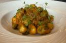 Potato gnocchi with sauteed courgette, tomato and basil sauce, and grated parmesan