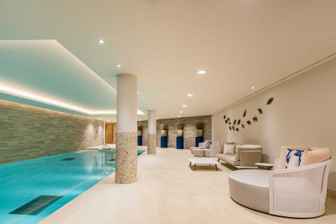 A swimming pool in a large living room.