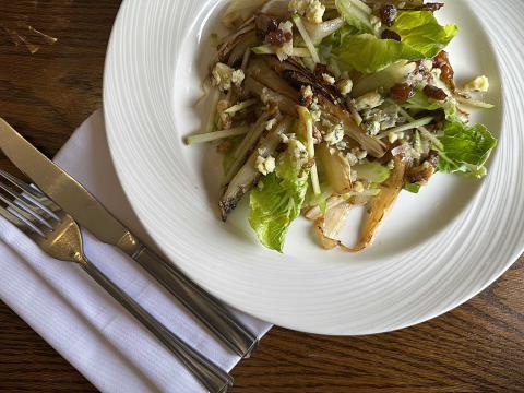 Caramelised endive with blue cheese and apple served with celery, walnuts and finished with a sultana and apple dressing